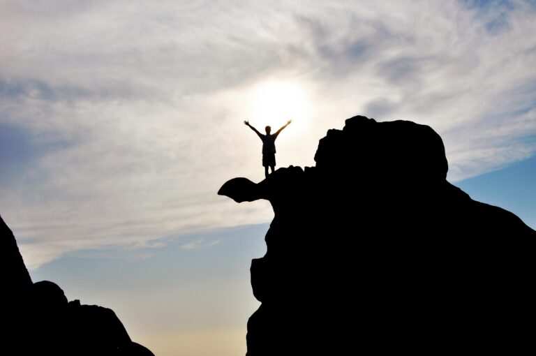 Graphic illustrating the pathway to Positive Thinking for Success with a person climbing towards a bright goal.