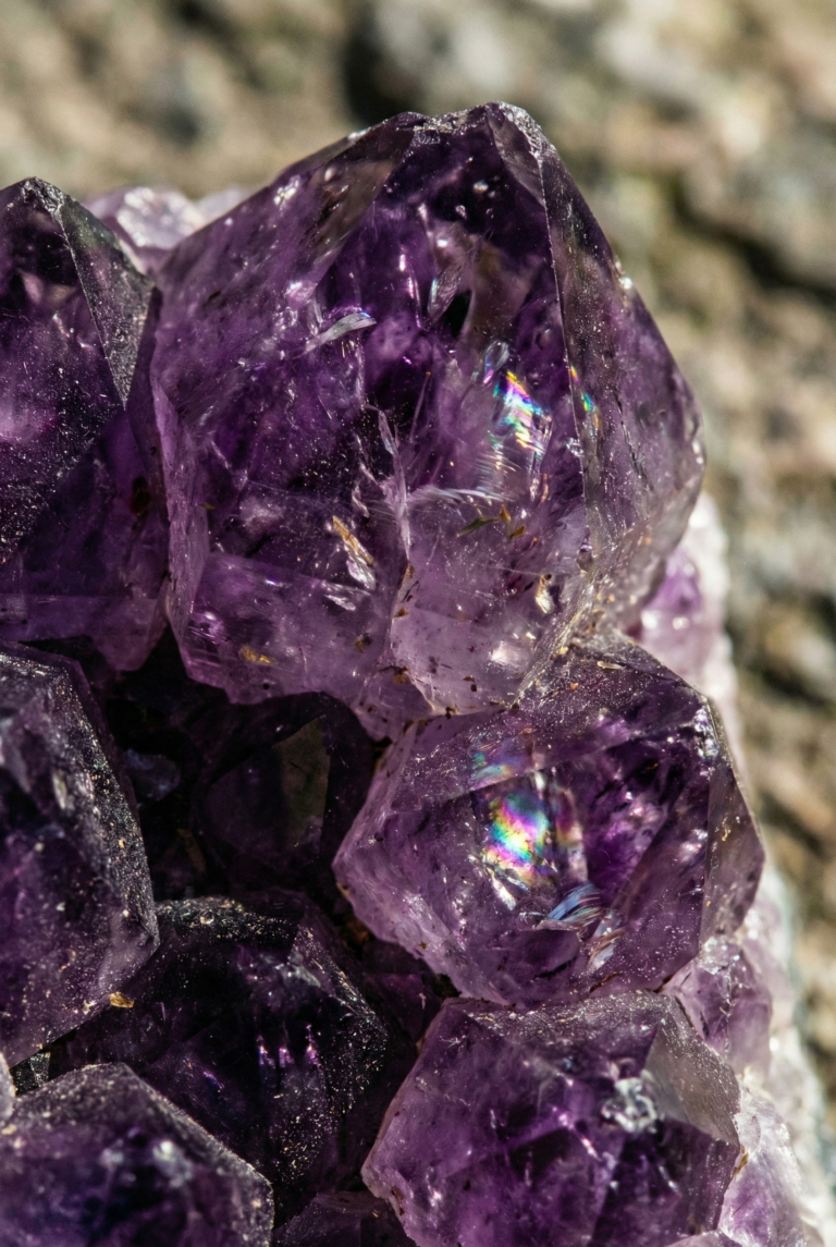 Extreme close-up of raw purple amethyst crystal showing internal fractures.