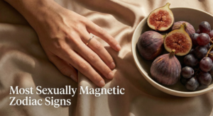 A sensual close-up photograph of a hand touching silk fabric next to a bowl of figs, with text overlay reading 'Most Sexually Magnetic Zodiac Signs'.